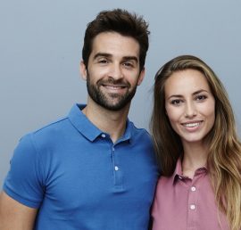Couple in polo shirts smiling for camera
