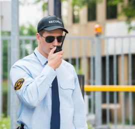 Close-up Of Male Security Guard Talking On Walkie-talkie