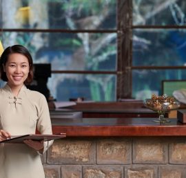 Portrait of Vietnamese receptionist at her workplace